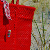 Handwoven red Oaxaca handbag with detail of no worries doll